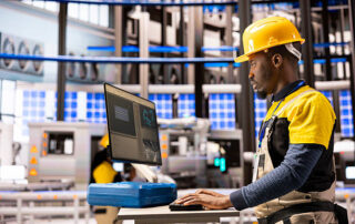 Black male technician manages autonomous manufacturing system, overseeing robotic arms and conveyor belts for improved industrial efficiency. Industry 4.0 specialist handles smart factory optimization