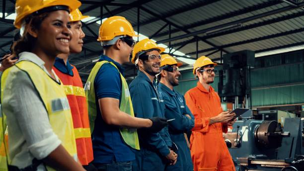 image4 Skillful worker attending brief meeting in the factory . Industrial people and manufacturing labor concept .